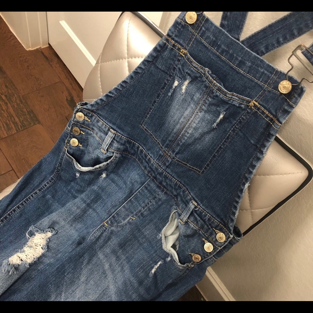 Distressed denim overalls